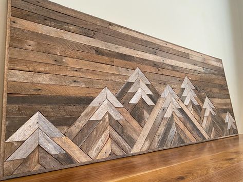 Each headboard is made to order, unique and one-of-a-kind. We partner with local Amish craftsmen who create each piece by hand, entirely without the use of electricity. They are made using reclaimed wood from antique houses in our local area of Kansas. We leave the wood untreated to allow it's natural warmth and character to show through.  Designed to be a wall-mount queen sized headboard, but could also work for a twin bed, full sized bed, as a statement wall art piece in a living room, above your couch, or even on a kitchen wall. Due to the variable nature of reclaimed wood, please expect slight variations from the photographs, including more/less nail holes and variations of wood texture and hue, chips, dings, etc. Hanging hardware will be included but not installed. We are happy to ans Wood Chevron Wall Art, Rustic Headboard Ideas Wood, Wood Tree Wall Art, Wood Art Piece Wall, Wood Picture Art, Mountain Headboard Diy, Simple Wood Wall Art, Wood Artwork Wall, Wood Mountain Wall Art Diy