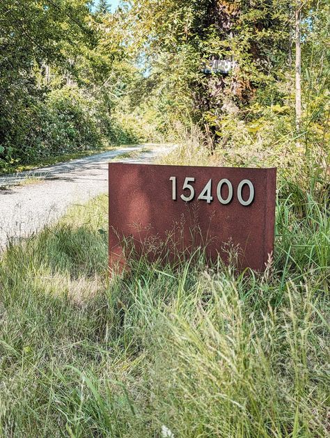 Our custom Rural Address signs are a must for your country driveway. The single piece of 12-gauge steel comes in a weathered patina, with floating 3.5" stainless steel magnetic letters and numbers that makes your address easy for guests to spot. Built to last for decades, our signs welcome you home. Installation: Typically the signs are buried 6-8 inches into the ground, depending on the soil type. Metal Yard Signs Outdoor, House Number Sign For Yard Driveways, Address Sign Ideas Driveway, Ranch Signs Entrance, Driveway Decor, Country Driveway, Circle Driveway, Driveway Sign, Modern Driveway