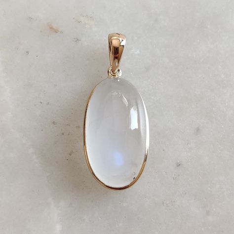 This stunning pendant is set in 14k Solid Yellow Gold with Natural Rainbow Moonstone with utmost precision. It is a unique gemstone pendant for nearly every occasion and is completely hassle-free jewelry. ITEM DETAILS: * GEM: Rainbow Moonstone * GEM Size: 11X18mm * GEM Shape: Oval * Gem Weight: 12.86 carats * Gold Purity: 14KT  * Gold Weight: 0.62 gram * Total Weight of the Pendant: 3.19 gram The Gold purity is guaranteed and it comes with an authentic 14KT gold hallmark. Since my items are handmade, they are absolutely nickel and lead free. CUSTOMIZATION: * Gemstone customization is available and it can be substituted with a gem of your choice. Kindly message me for the same. PACKAGING * The Pendant comes with layers of safe and secure wrapping along with a Free handmade jewelry box with Elegant Moonstone Gemstones Gift, White Oval Gemstones For Gifts, Rainbow Moonstone Necklace, Handmade Jewelry Box, Gemstone Pendant Necklace, Moonstone Stone, Blue Moonstone, Jewelry Christmas, June Birthstone