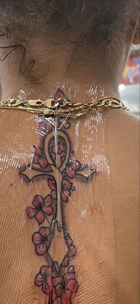 Ankh And Flowers Tattoo, Chest Tat Black Women, Rib Tattoo Black Women, Ahnk Tattoo Black Woman, Ankh Tattoo Women Chest, Red Tattoos For Women Brown Skin, Ankh Tattoo Women, In Between Chest Tattoo Female Black, Back Tattoo Ideas Female