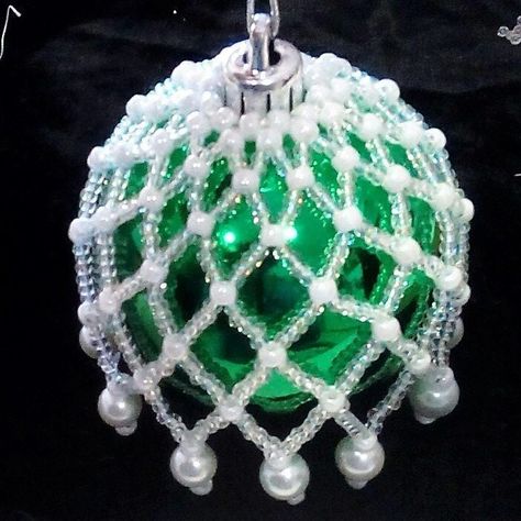 This is a listing for the PDF  downloadable BEADING PATTERN tutorial only. It has English text with diagrams and photographs to help. It is made with 8º and 6º seed beads and 6 or 8 8mm pearls. It fits over a 7-8 inch bauble (19-21 cm) The printable instructions are 7 pages. Viewing on a laptop or tablet allows enlarged diagrams and instructions Some experience in joining and finishing thread is advisable Beaded Ornaments Diy, Beaded Christmas Decorations, Beaded Ornament Covers, Art Perle, Holiday Beading, Bead Crochet Rope, Beaded Christmas Ornaments, Christmas Bead, Ornament Kit