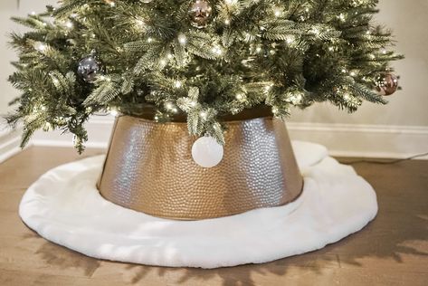 If you've jumped on the tree collar train this year, but are struggling with your collar being too short to reach the bottom of the tree, this blog post details a super quick and easy way to (literally) elevate your tree collar look! No need to make your tree shorter or buy a new tree stand, all you need is do is make your tree collar taller! Christmas Tree. Tree Collar. Tall Tree Collar. DIY. Designer Dupe. Crate and Barrel. Spray Paint. Mini Golden Bead Garland. Bells. Ornaments. Neutral. Elevate Christmas Tree, Bottom Of Christmas Tree Ideas, Tree Collar Diy, Tree Collar Christmas, How To Make Trees, Bells Ornaments, Diy Christmas Tree Skirt, Glam Christmas Tree, Christmas Tree Collar