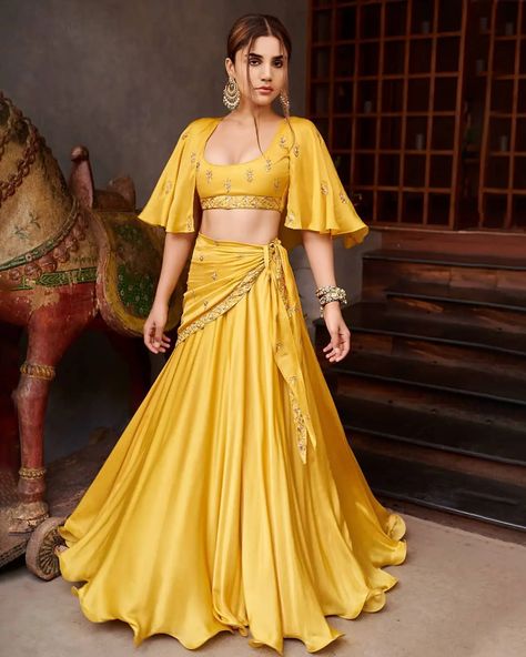 40 Latest and Trendiest Haldi Dress Options For The Bride and Her Sisters Yellow Crop Top Lehenga, Lehenga Skirt With Crop Top, Mustard Yellow Lehenga, Prathyusha Garimella, Crop Top With Skirt, Designer Crop Top, Orang India, Ceremony Outfit, Cape Lehenga