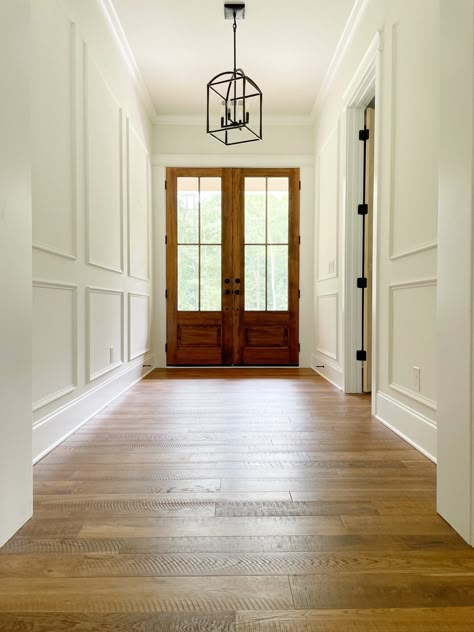 Wainscoting Entry Way, Hallway Crown Molding Ideas, Foyer Molding Entryway, Frame Molding Hallway, Traditional Picture Frame Molding, Hallway Framing Ideas, Wall Paneling Foyer, Foyer Paneling Entrance, Entryway With Molding