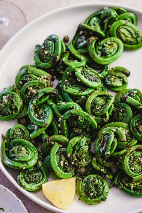 It's rare that an adventurous home cook discovers a truly unknown vegetable, but for many of us, the first encounter with fiddlehead ferns is precisely such an opportunity. Today, we dive into the enchanting world of sautéed fiddlehead ferns—a dish that's sure to leave you wondering why you've been neglecting these curly green wonders for so long. #sauteed #fiddlehead #ferns #fiddleheadferns Fiddlehead Fern Recipes, Fiddlehead Recipes, Fiddlehead Fern, Fiddlehead Ferns, Wild Food Foraging, Vegetable Side Dish, Vegan Kids, Green Veggies, Healthy Food Dishes