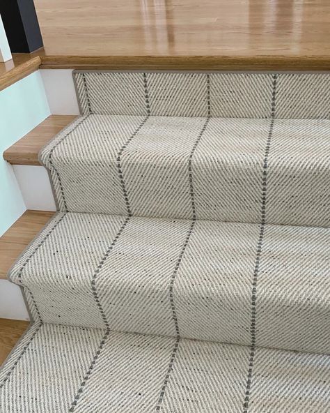 Check out this stunning stair runner makeover from @Nigohsian_Carpet  featuring our Martinique Collection collection in Linen.  Inspired by the natural grass weaves of the Caribbean, our Martinique Collection weaves a stylish tale with its chevron pattern and contrasting stripe. Available in five nature-inspired colors, the neutral linen beautifully complements these hardwood floors. Stairs With Patterned Carpet, Patterned Stair Carpet Ideas, Patterned Runner On Stairs, Wood Stairs Runner, Colorful Stair Runner Ideas, Wood Stair Runner, Stair Runners Ideas Hardwood, Patterned Stair Runner, Classic Stair Runner