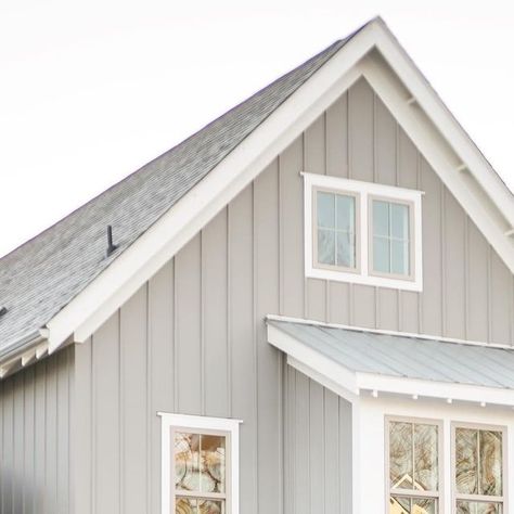 McNeill Burbank on Instagram: "Galvanized metal. Clay windows. Board & batten. A fresh perspective on the tenacious modern farmhouse. An architectural style that remains timeless yet relevant with details that universally feel familiar, peaceful and nostalgic. Home feat. is our award-winning Heritage home completed in the charismatically charming town of Carrboro, North Carolina. The Heritage is currently archived in our portfolio. Similar plans are available to design & build. Visit our site for details – link in bio. Dorian Gray SW 7017 (B&B) Eider White SW 7014 (Siding, Trim)" Board And Batten Metal Siding Colors, Board And Batten Siding With White Windows, Clay Windows Exterior, Gray Board And Batten Exterior, Metal Siding Colors, Apartment Bathrooms, Eider White, Board And Batten Exterior, Gray House Exterior