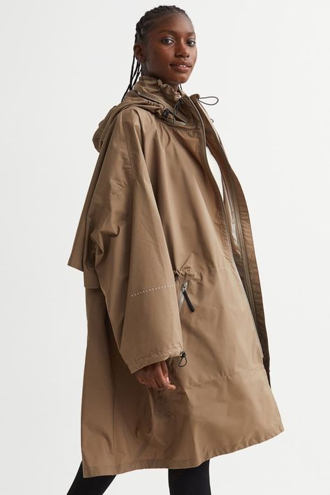 These Raincoats Are So Effortlessly Cool, You'll Even Wear Them on Sunny Days Rain Parka, Hooded Raincoat, Raincoats For Women, Dark Beige, Oversized Jacket, Down Parka, Oversized Silhouette, Sport Wear, Fashion Company