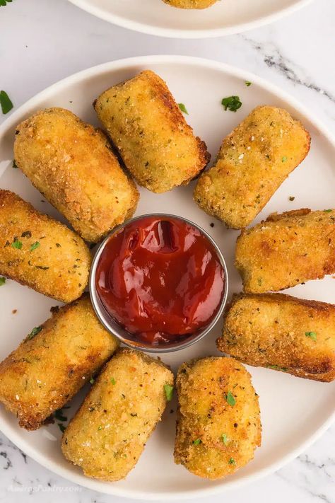 Potato croquettes in a white serving platter. Potatoe Bites Appetizers, Anise Biscotti Recipe, Potato Pastry, Greek Eggplant Dip, Anise Biscotti, Greek Eggplant, Potatoes Wedges, Baked Brie In Puff Pastry, Potato Croquette Recipe