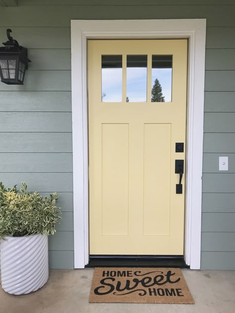 Light Yellow Door Exterior, Hawthorne Yellow Benjamin Moore Exterior, Yellow And Grey House Exterior, Front Porch Yellow House, Lake Cottage Front Door, Soft Yellow Front Door, Yellow Front Door Cottage, Butter Yellow Front Door, Yellow Door Paint Color