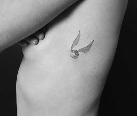 Golden Snitch by Jakub Nowicz Tiny Harry Potter Tattoos, Golden Snitch Tattoo, Snitch Tattoo, Harry Tattoos, Hp Tattoo, Tattoos Inspo, Potter Tattoo, Ribcage Tattoo, Hip Tattoos Women