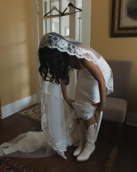 Tory getting ready to become Mrs. Whitney 🤎🥹 Tory is probably the most chill, go with the flow bride. Just minutes before she was ready to walk down the aisle it started pouring.. and she was like “I’m down to get wet” The clouds made for such a moody wedding day and it fit the feel of their wedding so much - romantic, calming, peaceful Also a bride that wears her boots under her dress.. southern icon Texas wedding photographer, Texas photographer, Dallas photographer Cowboy Boots Under Wedding Dress, Bride Wearing Boots, Wedding With Cowboy Boots, White Boots Wedding Dress, Wedding Cowboy Hat Bride, Cowgirl Boots With Wedding Dress, Wedding Dress With Cowgirl Boots, Cowgirl Wedding Dress With Boots, Wedding Cowboy Boots For Bride