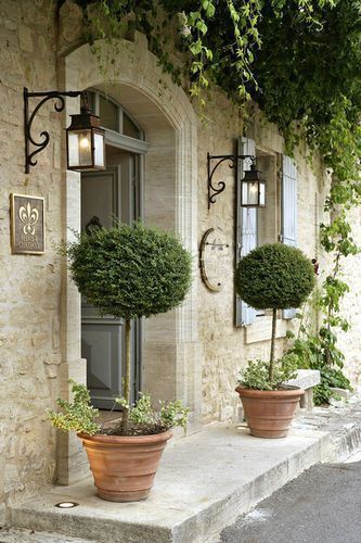 French Country Home | Topiaries, stonework and black scrolled iron on the light fixtures create a breathtaking entry that is still a little bit understated. French Farmhouse Decor, French Country Design, Have Inspiration, French Cottage, French Country Cottage, Front Entrances, French Farmhouse, Country Design, French Country House