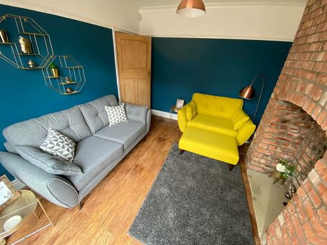 Redecorated our back room using a Blue and Gold accessories theme with grey furnishings to break up the bold colours.   Decided to add a pop of bright yellow in a cuddler chair to complement the gold 💛 .  #blue #gold #livingroom #grey #yellow #brickchimneybreast Blue Gold Living Room, Brick Chimney Breast, Blue And Gold Living Room, Cuddler Chair, Gold Living, Back Room, Blue Lounge, Yellow Chair, Gold Living Room