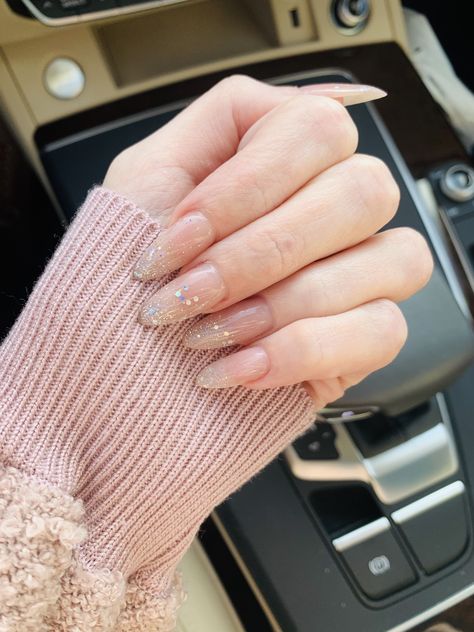 Nude with glitter ombré almondetto nails! Perfect for holidays, parties, New Year’s Eve, etc. Nude Party Nails, Nude With Gold Glitter Nails, Almond Party Nails, Clear Polygel Nails Design, Nude Nails With Glitter Tips, Nude Glitter Ombre Nails, Nude Ombre Nails With Glitter, Nude Glitter Acrylic Nails, Almond Sparkle Nails