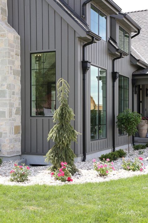 Monotone Exterior House Paint, Woodtone Siding Aspen Ridge, Iron Ore Farmhouse Exterior, Simple Modern Home Exterior, Porch Different Color Than House, Medium Gray House Exterior, Gray Vertical Siding Exterior, Light Grey House Black Windows, Light Grey Barndominium Exterior