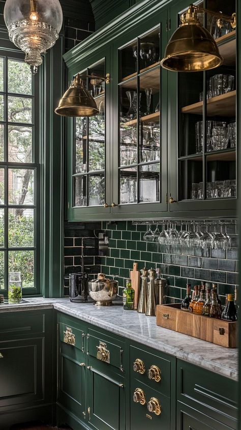 Dark green kitchen cabinets with glass doors, marble countertops, and brass hardware in a classic New Orleans mansion. Kitchen Island Ideas Green, Dark Green Small Kitchen, Green Cabinets Brown Granite, Green Subway Tile Backsplash, Emerald Green Kitchen, Dark Green Cabinets, New Orleans Mansion, Green Kitchen Cabinet, Green Cabinet