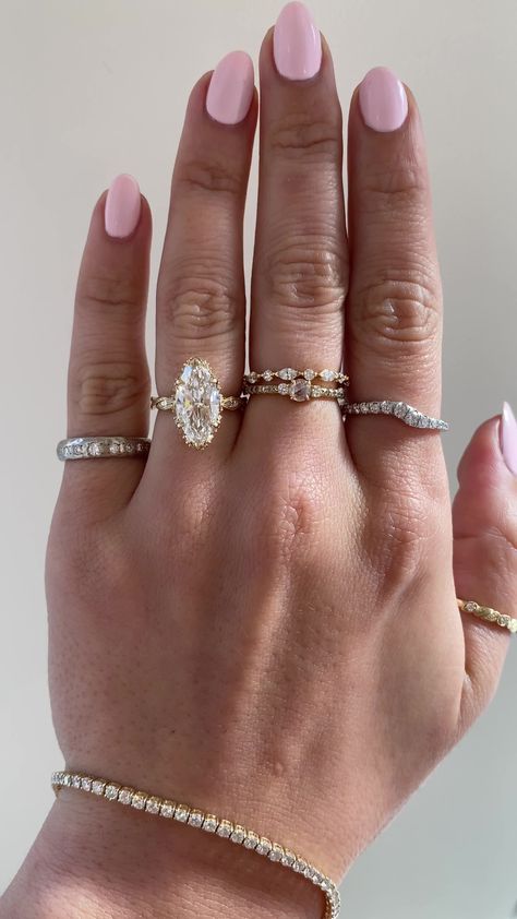 Inspired by our Odessi, just scaled down in width, the Odette showcases an intricate vintage inspired design that runs all the way around a her band with white diamonds set within the features of the band. This desired design is the perfect combination of vintage chic and glamour. Drop-down diamond options represent our recommended grade, which maximizes size for value, while maintaining eye-perfect clarity and giving you a colorless look. For other diamond options, see our Shop Diamonds tab or Rings Engagement Marquise Bridal Sets, Princess Ring Stack, Stacked Wedding Bands With Halo Ring, Marquise Ring And Band, Old Mine Moval Engagement Ring, Antique Moval Engagement Ring, Marque Diamond Ring, Two Pear Diamond Ring, Gold Wedding Rings Thick Band