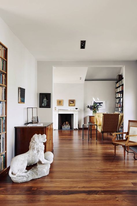 The living room in [link url="http://www.houseandgarden.co.uk/interiors/real-homes/charles-rutherfoords-elegant-london-house"]Charles Rutherford's London home[/link] is decorated in a simple, elegant style with white walls and wooden floors. The desgin reflects current architectural ideas surrounding the play of light and flow of space. Instead of architectural mouldings, there are shadow gaps at the top of walls painted a shade of luminous blue-grey. Dark Wood Living Room, Wooden Floors Living Room, White Walls Living Room, Living Room Units, Dread Locks, Living Room Wood Floor, Room Furniture Design, Flooring Inspiration, Furniture Design Living Room