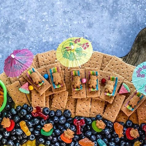 Maegan Brown ~ The BakerMama on Instagram: "Hello Summer! ☀️😎 Oh to be a teddy graham sunbathing in an ocean of blueberries all summer long! 😜 we love to kick-off summer with this adorably fun summer snack board built with a tasty selection of fresh fruits and creative sweet treats! 🏖🦈🦞☀️ All of the yummy details for this snack board are in my Beautiful Boards cookbook (page 71). I promise building (and destroying! 😉) this board is way more fun than sand castles! 🤭🪣🏰 #BoardsByTheBakerMa Under The Sea Fruit Platter, Ocean Charcuterie Board, Under The Sea Charcuterie Board, Teddy Graham Beach, Summer Snack Board, Summer Kids Snacks, Pool Party Snacks, Beach Dessert, Class Mom