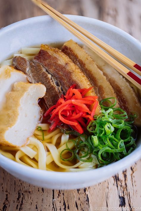 A classic Okinawan dish - Okinawa Soba. Chewy flat noodles, braised pork belly slices, fish cake, green onion, and red pickled ginger in a delicious Japanese dashi and pork broth. #Okinawa #OkinawaSoba #JapaneseFood #AsianFood | Easy Japanese Recipes at JustOneCookbook.com Okinawa Soba Recipe, Okinawa Food, Soba Recipe, Okinawa Diet, Flat Noodles, Pork Belly Slices, Pork Broth, Easy Japanese Recipes, Braised Pork Belly