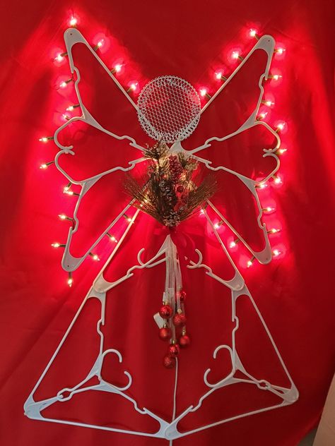 Hanger crafts seem to be all the rage this year! Here is my version of a festive Christmas Angel made with Dollar Tree items. It's easy to make and can be used indoors and out! Plastic Coat Hanger Angel, Angel Hanger Craft, Plastic Hanger Star Diy, Crafts Made From Plastic Hangers, Clothes Hanger Angel, Angel Christmas Decorations Diy, Clothes Hanger Christmas Decorations, Plastic Coat Hanger Angels, Star Made Out Of Plastic Hangers