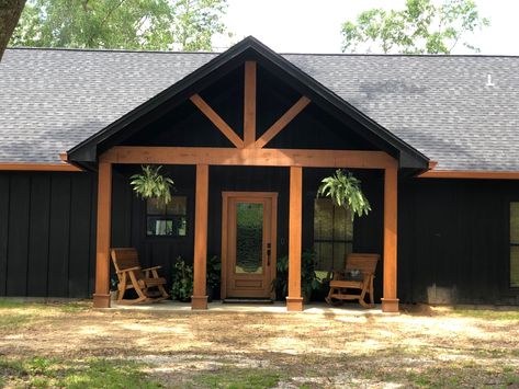 Black Board And Batten House, Black And Copper Metal House, Black And Cedar Porch, Black Tin House Exterior, Black And Cedar Ranch House Exterior, Black Metal House With Wood Accents, Cedar And Black House, Black Vinyl Siding House, Black Siding Cedar Accents