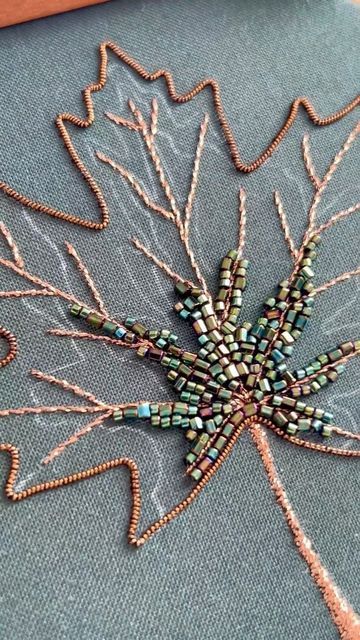 Kate • Hand Embroidery Artist on Instagram: "A short video of what I’ve finished so far on my current work in progress, a beaded maple leaf. 🍁 

I started out stitching an outline with some goldwork wire that isn’t actually gold, lol. In fact it’s a really pretty bronze-brown. Then I used a metallic embroidery thread to fill in the leaf stem and veins. Finally it’s on to the beading, which is what we’re all here for!

As you can already tell, this maple leaf isn’t going to be the typical fiery orange in the height of Fall foliage. I actually decided to go a more transitional color palette, so the beads closest to the leaf center are still a deep green. You’ll just have to stick around to see how the rest of the beading turns out! ☺️✨

#goldworkembroidery #beadembroidery #embroideryartist Transitional Color Palette, Embroidery Pins, Gold Work Embroidery, Embroidery Leaf, Metallic Embroidery, Gold Work, Bead Embroidery, Artist On Instagram, Fall Foliage