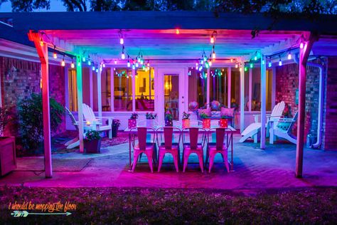 Colorful Patio Makeover | Lots of fun, whimsical, homemade touches, and colorful lights make this patio a great spot to hang out! Fun Outdoor Lighting, Neon Patio Decor, Colored Outdoor Lights, Colorful String Lights, Funky Patio Ideas, Colorful Backyard Decor, Colorful Outdoor Patio, Colorful Backyard, Colorful Patio Ideas