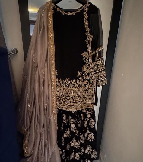 It’s all about black, a perfect wedding outfit for this upcoming wedding season Black formal outfit with zardozi work on shirt paired with embellished gharara and gotta finished silk dupatta For order and details please dm | visit kehkeshan.aamir | or whatsapp us on 03115693004 [ Kehkeshan kehkeshanz black gharara formal wedding wear laamofficial Pakistanifashion ] Black And Gold Gharara, Black Sarara Dress, Gold Gharara, Black Formal Outfit, Black Gharara, Sarara Dress, Cotton Sharara, Desi Outfits, Zardozi Work