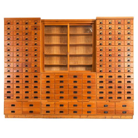 Extreme large apothecary chest which counts a total of 156 drawers! This beautiful piece is made from redwood and is build up in eleven elements each divided with drawers in different sizes. One additional element includes an integrated showcase which makes this piece complete and really fills the room. Mixed Furniture, Art Setup, Apothecary Chest, Library Cabinet, Metal Cabinets, Wood Wardrobe, Apothecary Cabinet, Antique Cabinets, Store Fixtures