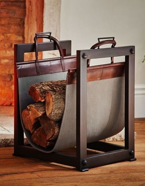 A sturdy iron frame and canvas-and-leather sling on Pottery Barn';s Industrial log carrier/holder make it both handsome and functional | archdigest.com Industrial Fireplace, Indoor Firewood Rack, Firewood Storage Indoor, Log Carrier, Firewood Holder, Industrial Inspiration, Fireplace Logs, Small Fireplace, Firewood Rack