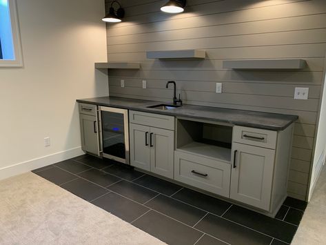 Wet bar idea for basement; I like the shiplap walls, the lights, the greyish color and the shelves.  Simple yet functional. Basement Wet Bar Backsplash, Basement Wet Bar Flooring, Kitchen Bar Accent Wall, Shiplap Bar Ideas, Small Wet Bar Ideas Basement, Bar Against Wall Basement, Simple Wet Bar, Shiplap Bar Wall, Basement Wet Bar Ideas Small Spaces