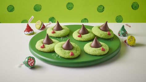 Merry Grinchmas! Grow your heart three sizes with this green Grinch® cookie, inspired by the mean one himself and topped with a HERSHEY’S KISSES Chocolate. Hershey Kisses Chocolate, Grinch Cookies, Sugar Cookie Mix, Blossom Cookies, Chocolate Sugar Cookies, Hershey's Kisses, Peanut Butter Blossoms, Milk Chocolate Candy, Holiday Cookie Recipes