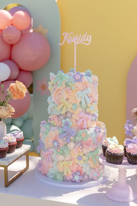 Kassidy's Sweet & Colorful Flower & Bows Birthday Party • Beijos Events Pastel Colored Birthday Party, Baking Themed Cake, Baby Shower Pastel Colors, Cake With Colorful Flowers, Flower Themed Birthday, Pastel Color Party, Flower Bows, Flower Birthday Party, Backyard Birthday Parties