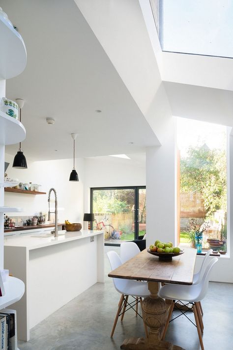 Natural wooden table and Eames chairs shape the small dining nook Polished Concrete Floor Kitchen, Concrete Floor Kitchen, Kitchen Concrete Floor, Concrete Lights, Modern Victorian House, Concrete Kitchen Floor, Polished Concrete Kitchen, Small Dining Nook, Floor Concrete