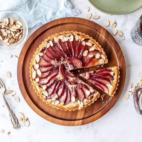 The classic frangipane tart filled with light and creamy frangipane filling and layers of red wine poached pears baked in an amazing melt in your mouth buttery tart crust! This is the perfect Holiday dessert! It might seem complicated (and there are multiple steps to this recipe) but each step is quite simple. I'll show you everything step by step from making the tart dough, blind baking the crust, making frangipane and poaching pears in red wine. This tart is a Christmas day show-stopper! Red Wine Poached Pear, Red Wine Dessert, Pear Frangipane Tart, Wine Poached Pears, Sugar Geek, Tart Crust, Pear Pie, Pear Dessert, Frangipane Tart