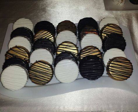 Chocolate Covered Oreos  Gold , black , white , drizzle Black Birthday Treats, Black White And Gold Chocolate Covered Oreos, Black And Gold Oreos, Black And Gold Theme Dessert Table, Black White Gold Dessert Table, Roaring 20s Desserts, New Years Chocolate Covered Oreos, Black And Gold Chocolate Covered Oreos, Black White And Gold Desserts