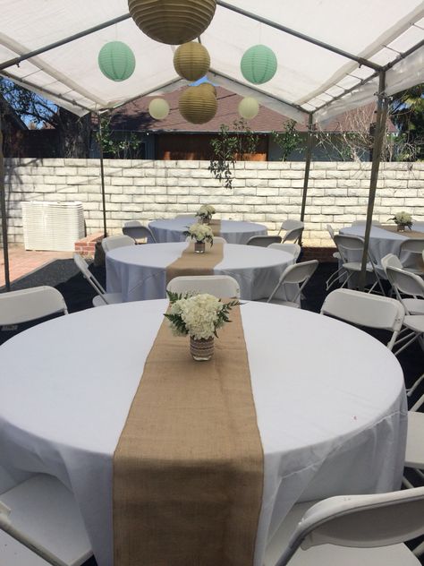 Burlap Liner on white table cover with Mason Jar DIY; burlap ribbon, Hydrangeas, Baby Breath, green leaves Burlap Table Decorations, Cowboy Themed Birthday Party, Burlap Baby Showers, White Table Cover, Round Table Decor, Burlap Tablecloth, Wedding Archway, Graduation Tables, Baby Shower Theme Decorations