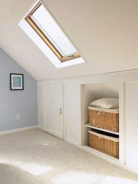 a pretty neutral attic room with built in storage   baskets for storage and storage compartments with doors is amazing Build Attic Storage, Attic Bathroom Closet Combo, Small Attic Loft Ideas, Attic Eaves Storage, Eaves Storage Sliding Doors, Attic Storage Ideas Low Ceilings, Attic Room Storage Ideas, Storage Sloped Ceiling, Eaves Storage Ideas Angled Ceilings