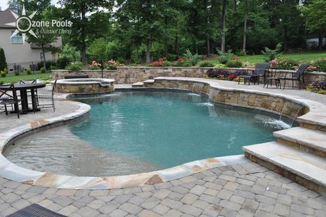 Freeform Pool/Spa with Stone Retaining Wall Retaining Wall Pool, Pool Retaining Wall, Backyard Retaining Walls, Pool Diy, Freeform Pools, Pool Outfits, Stone Retaining Wall, Pool Remodel, Spa Ideas