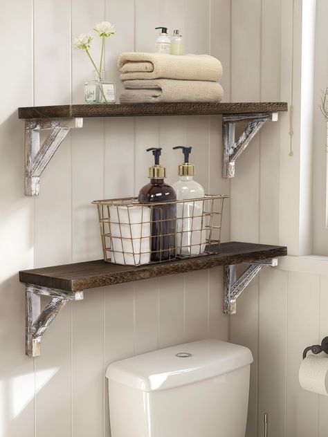 PRICES MAY VARY. This floating shelf set is constructed of durable paulownia wood, featuring a natural wood texture, lightweight, and wear-resistant The wall shelf comes with all necessary mounting accessories, making installation a breeze. Adjust the triangular support position as needed Measuring size: 24*6*6.5 inch, which can effectively expand your storage space. 0.8in thickness plate is not easy to deform and warping Carbonized black plate and whitewashed bracket, a fusion of the rustic and Wood Shelf Bathroom, Bathroom Wood Shelves, Dark Wood Bathroom, Shelves Over Toilet, Bathroom Shelves Over Toilet, Shelves For Wall, Toilet Shelves, Bathroom Wall Shelves, Shelf Bathroom