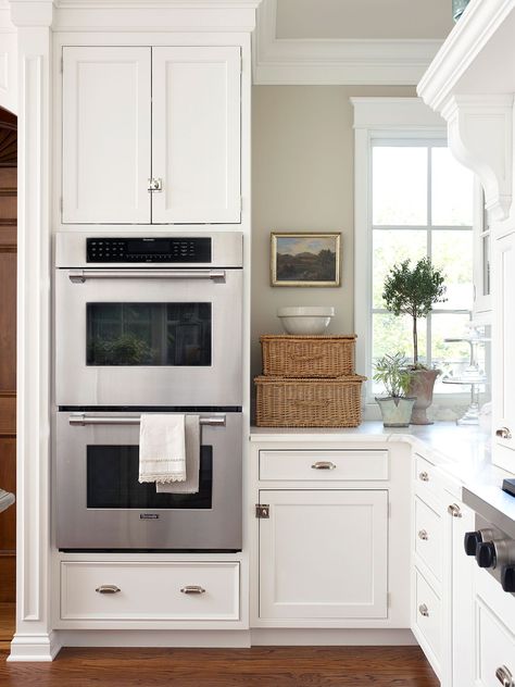 Typically stacked and built directly into perimeter cabinetry, double ovens provide a sleek look and added convenience. This kitchen feature offers a main oven you can use without bending over and a secondary oven for plate warming and additional baking. #kitchenideas #kitchenremodel #kitchenplanningideas #kitchenmakeover #bhg Wall Oven Kitchen, Outdoor Kitchen Countertops, Fixer Upper Style, Kitchen Decor Themes, Kitchen Designs Layout, Kitchen Design Trends, Kitchen Farmhouse, Smart Kitchen, Kitchen Trends