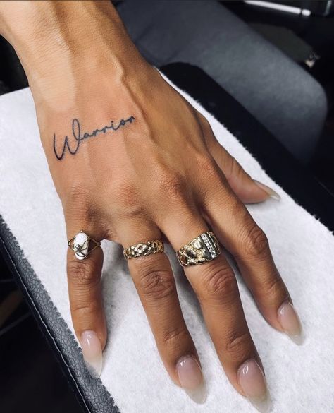 Pretty Tattoos For Women Hand, Create Tattoos, Word Tattoos Hand, Small Hand Tattoos On Black Women, Warrior Hand Tattoo, Black Women Hand Tattoos, Name Tattoo Hand, Hand Tattoos Sayings, Minimalist Hand Tattoos