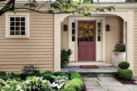 26 Exterior Tan Color Schemes That Pros Turn to Over and Over Again Tan Sided House Color Schemes, Tan House Exterior Door Color, Porch Colors For Tan House, Beige Siding With Shutters, Tan House Brown Roof, Houses With Tan Siding, Shutter Colors For Beige House, Tan House Colored Door, Tan House Shutters