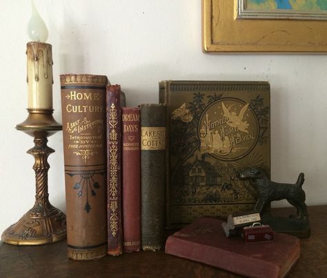 Books On A Mantle, Books On Mantle, Using Vintage Books As Table, Dark Academia Candle Holder, Vintage Books Display, Antique Books Wedding Decor, Mantle Candles, Cottage Library, Moody Farmhouse