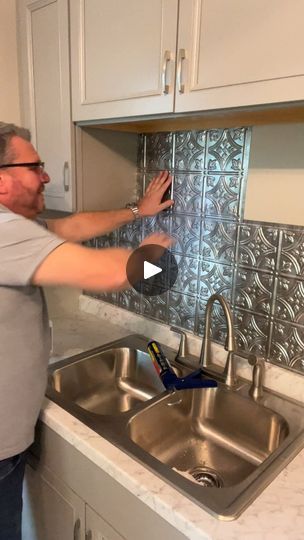 Showing how to apply facade faux tin tile backsplash | tile | Join John and I as we show you how to apply a facade faux tin tile backsplash. | By The Crafty DecoratorFacebook Facade Backsplash Kitchen, Copper Tin Backsplash, Tin Tile Backsplash Kitchen, Stove Backsplash Ideas, Pressed Tin Backsplash, Ceiling Tile Backsplash, Tin Ceiling Backsplash, Tin Tile Backsplash, Crafty Decorator