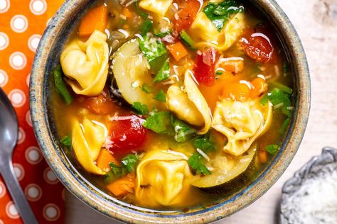 This soup has all the familiar comfort of a classic minestrone, but with the unexpected addition of fresh tortellini instead of the typical beans and elbow macaroni. Tortellini Vegetable Soup, Ellies Real Good Food, Ellie Krieger Recipes, Nourishing Soup, Warm Soup Recipes, Ellie Krieger, Minestrone Soup, Cheese Tortellini, Tortellini Soup