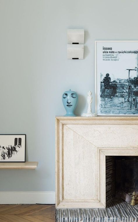 In the master bedroom in Alexandra Fain Sur's apartment, a Fornasetti vase perches on the mantelpiece, while the alabaster and iron wall light is by Pierre Chareau. Pierre Chareau, Lamp Inspiration, Townhouse Interior, Inspiring Interiors, Paris Apartments, An Architect, Dream House Interior, Fireplace Design, Iron Wall