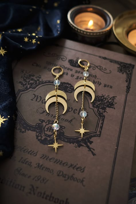 * Mystical and elegant dangling earrings, representing the phases of the Moon, decorated with stars and beautiful glass beads in dark blue, iridescent clear, or dark purple. Will give your outfit an instant touch of Magic :) * These beautiful dangling earrings have a witchy, bohemian feel to them.  * Stainless steel! * The total length of the earrings is approximately 9 cm (aprox 3.5 inches), hook included.  * They come in a pretty little pouch 🖤 Boho Dangle Earrings, Cute Dangling Earrings, Celestial Jewelry Aesthetic, Mystical Earrings, Celestial Accessories, Celestial Goth, Moon Earring, Dark Academia Earrings, Moon Beads